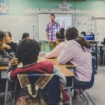 Teacher in a classroom full of enthusiastic learners.